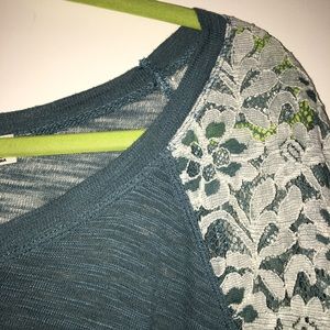 Teal sweater with lace details.